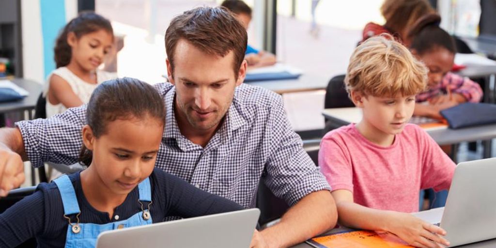 programmer using AI assistant on computer in modern office