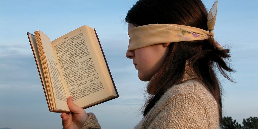 person reading a manual in front of a computer with Jenkins interface on the screen