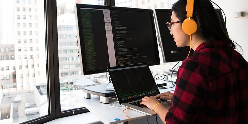 modern office with developers using computers and AI technology