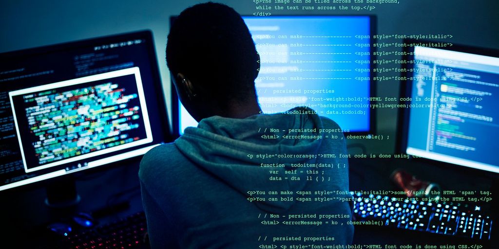 programmer coding on computer with AI assistant visible on screen
