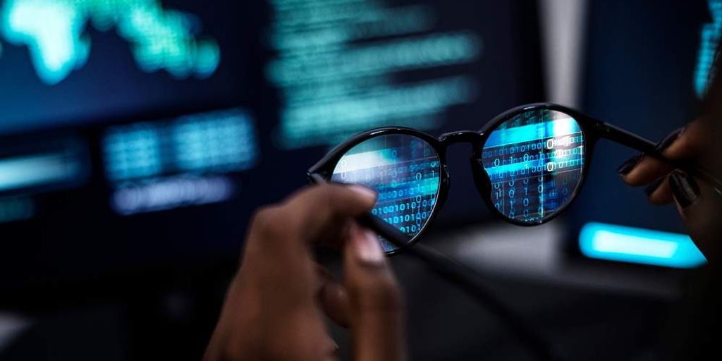 programmer using Microsoft Copilot on computer in modern office