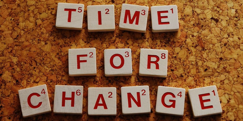 DevOps team working on computers in modern office with automation flowcharts and software deployment diagrams