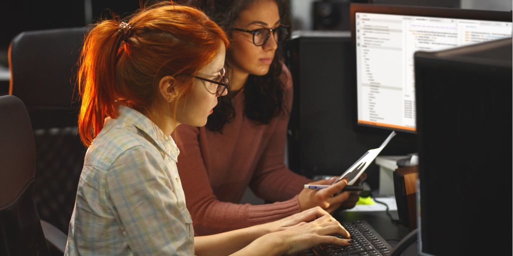team of software developers working together in an office, focusing on continuous testing and agile development