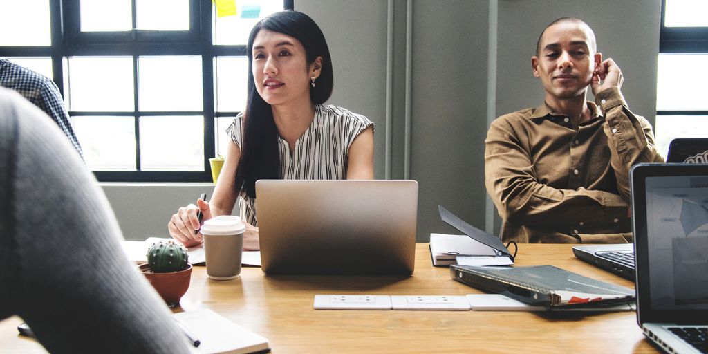 team collaboration on computer with GitLab interface