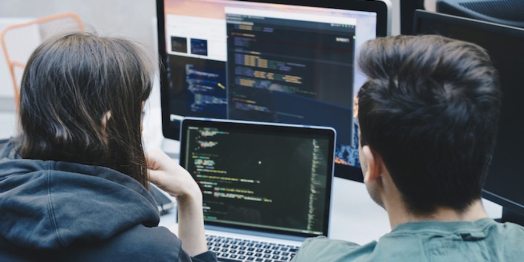 person using laptop to access code repository on GitLab