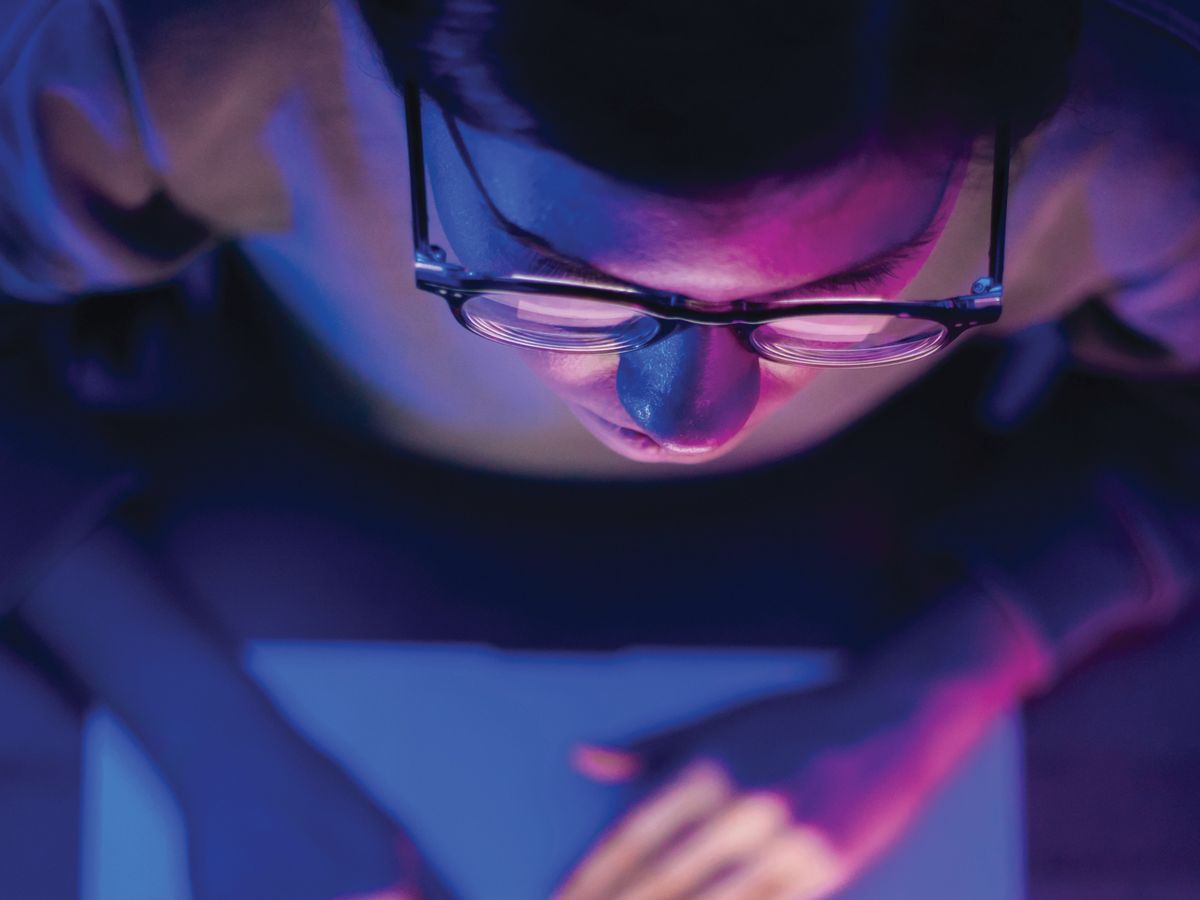 person using laptop with GitLab on screen