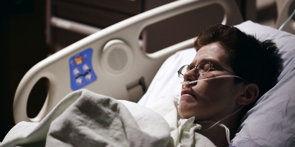 man in blue hoodie wearing eyeglasses